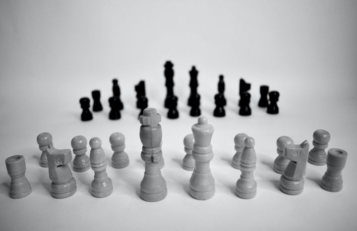 Chess pieces lined up on opposing sides